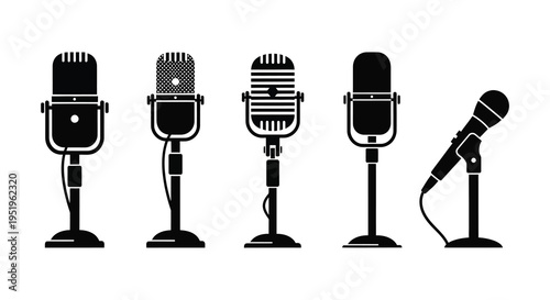 A collection of five vintage and modern microphones on stands