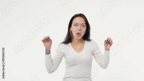 A young adult woman scares and laughs at a joke white background isolated space
