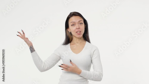 Young adult woman talks about demonstrates and teaches a business lesson presentation white background isolated space