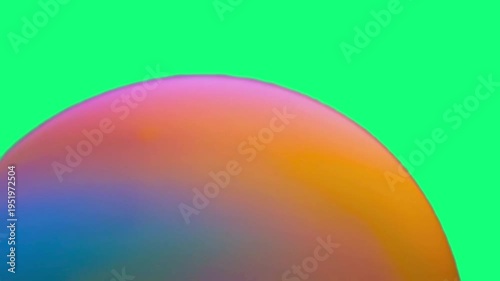 A colorful holographic sphere against a green screen, ideal for technology, marketing, or design concepts.