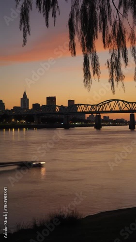 City skyline at sunset by water.