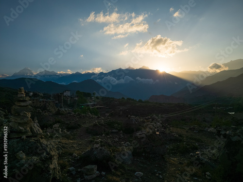 panoramic view over Muktinath in Nepal, coming down from Thorang La Pass, With the impressive Dhaulagiri II in the background At sunset