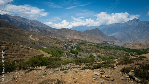 panoramic view over Muktinath in Nepal, coming down from Thorang La Pass, With the impressive Dhaulagiri II in the background