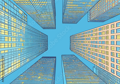 Looking up at tall buildings in a city during daytime under a clear blue sky