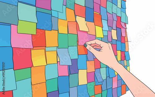 Colorful sticky notes arranged on a wall with a hand placing a note in a busy workspace during the day