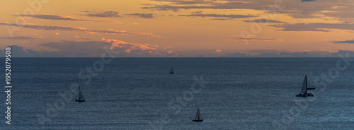 Sailboats Silhouetted on Pacific Ocean at Sunset in Hawaii