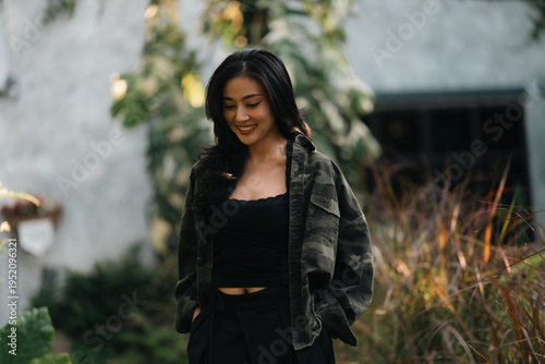 Asian woman relaxing in forest nature wellness mindfulness peaceful outdoor lifestyle mental health wellbeing natural therapy environment calm happiness sitting among trees