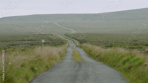 Static shot of a single-track road with a passing place on a Hebridean moor.