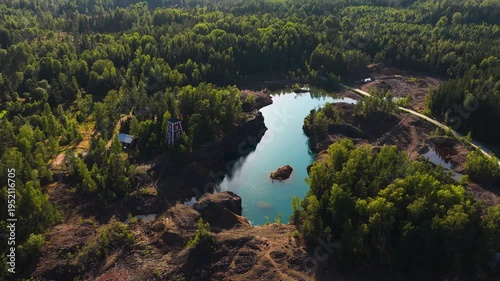 Aerial view around a light blue copper lake, at sunny Orajarvi, Salo, Finland