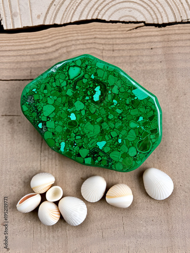 Malachite on wooden background, small shells on a wooden backgro