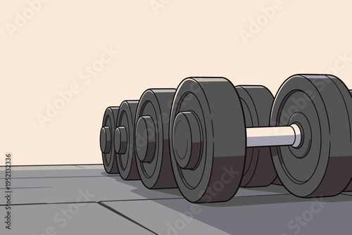Weights are lined up on a gym floor ready for workout session in a fitness center during the day