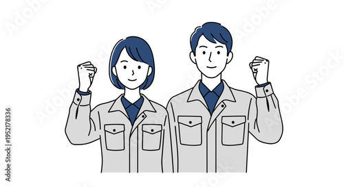 Two diverse workers male and female in matching workwear raising fists in triumph celebrating success