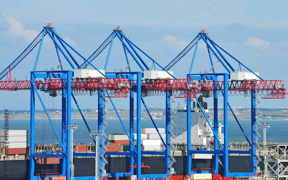 Fototapeta premium Crane loading container to cargo ship deck