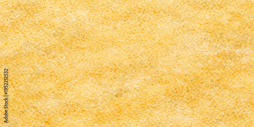 Abstract macro detail of a yellow wool fabric texture with a soft sponge pattern and beige wheat tones resembling a textured bakery bread background