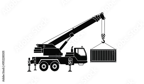 A heavy duty mobile crane lifting a large metal shipping container at a busy industrial worksite