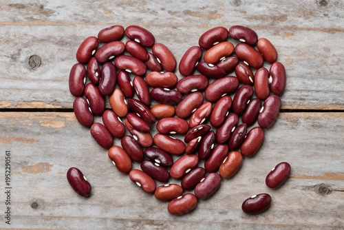 red beans in the shape of a heart on a wooden table