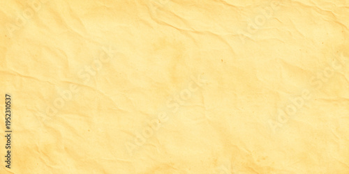 Yellow crumpled paper texture background with wrinkles and creases for design and decoration