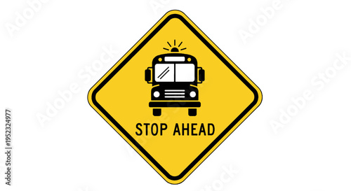 A yellow diamond road sign displaying a black school bus icon and the words "STOP AHEAD.