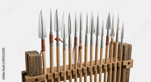 A collection of spears in a wooden rack with leather accents and sharp metal points