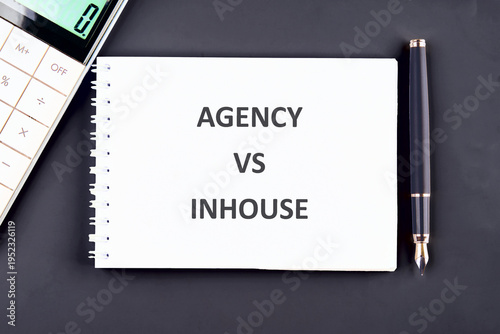 Photos White notebook, pen, calculator on dark desk
