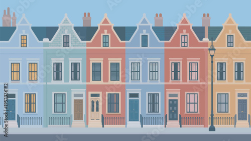 A row of colorful townhouses with a street lamp on a quiet suburban street