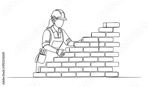 A female construction worker building a brick wall with a hard hat