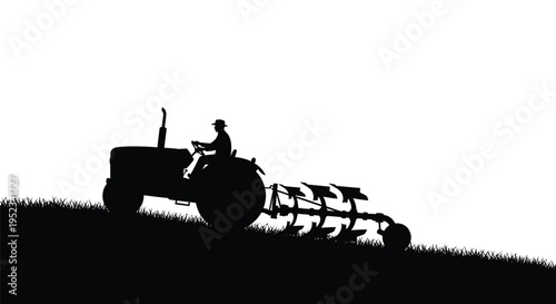 Farmer operating a vintage tractor with a plow dramatic silhouette