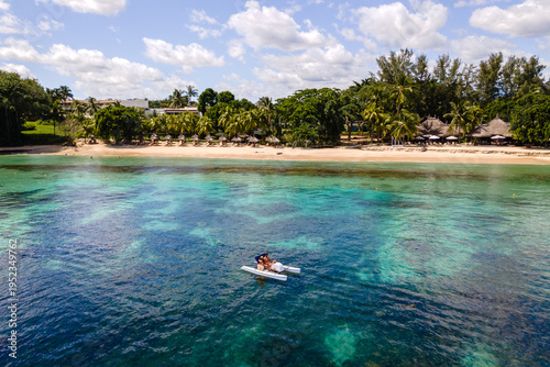 Obraz na plátně Serene couple kayaking on the crystal-clear waters of Triolet in Mauritius