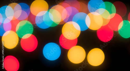 Colorful bokeh lights in various shapes and sizes on a dark background with a mix of vibrant colors and blurry effects