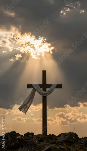 Wooden cross with cloth rises against a sky filled with golden clouds