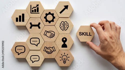 Building professional skills concept with a hand placing 'SKILL' wooden hexagon into a grid of career development icons