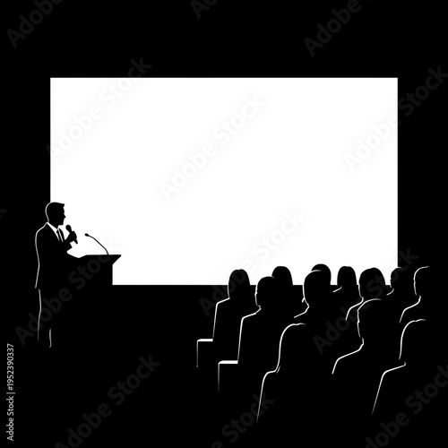 Man presenting to audience in darkened room.