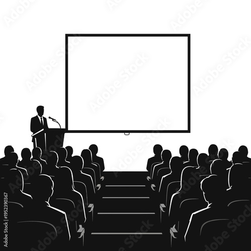 Man presenting to audience in auditorium setting.