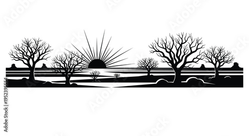 Dramatic desert landscape with sunburst and barren trees a silhouette