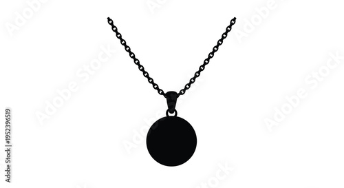 A simple silver necklace with a circular pendant a dark silhouette