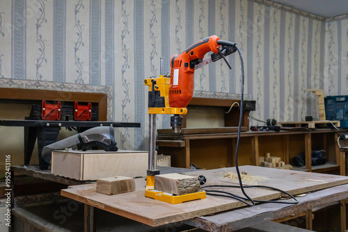 Bench drill press machine on wooden table for precision drilling