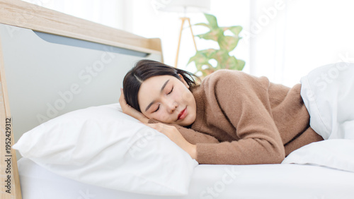 Asian happy woman healthy sleep peacefully girl good rest calm dream nap feel comfortable recovery on weekend morning enjoy lying pillow fresh soft cozy bedding natural light relaxing at home wellness