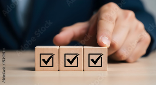 A person places wooden blocks with checkmarks on a table indoors.
