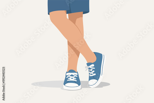Person's lower half in blue sneakers and shorts, feet crossed, symbolizing casual style, comfort, and cool attitude
