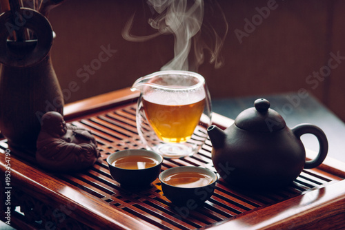 Teapot and cups with Chinese tea on the table for the tea ceremony
