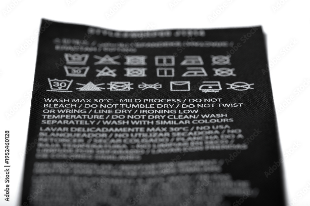 Fototapeta premium Macro photography of clothing label with instructions, expressed by means of graphic symbols on how to clean