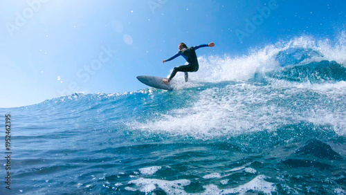 SUN FLARE: Cool surfer dude carves a beautiful blue tube wave near Fuerteventura