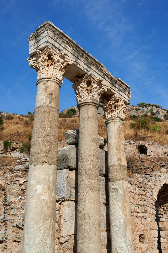 Fototapeta premium Architecture, pillars and roman ruins in countryside, history and travel with archaeology outdoor. Column, broken and heritage site in nature for tourism, ancient culture and background in Italy