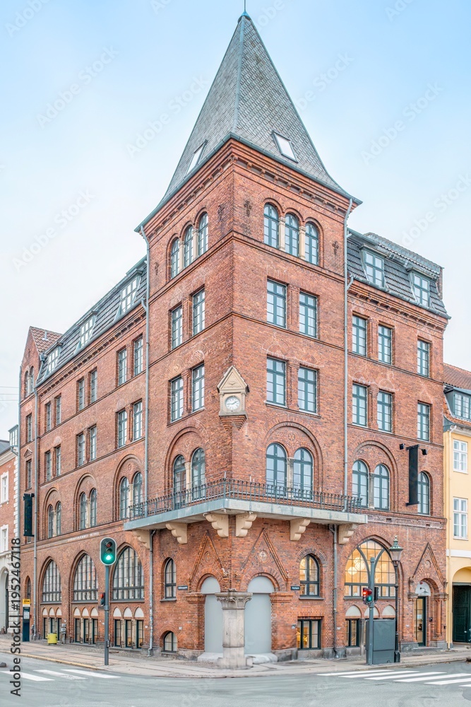 Fototapeta premium Historic Red Brick Corner Building Architecture in Copenhagen, Denmark, Danish Facade