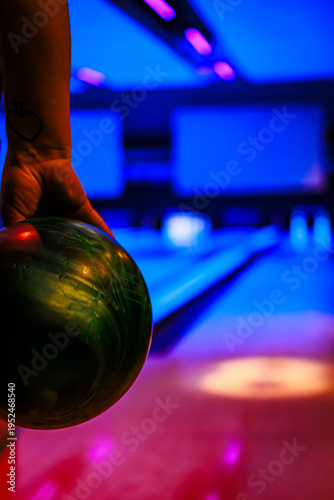 Fotografie Colorful Bowling Balls on a Rack with dark Blue Ambient Lighting