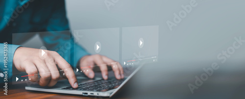Close up of hands using laptop with virtual video player interface overlay, representing streaming media technology, online learning, content creation, digital marketing, and multimedia entertainment