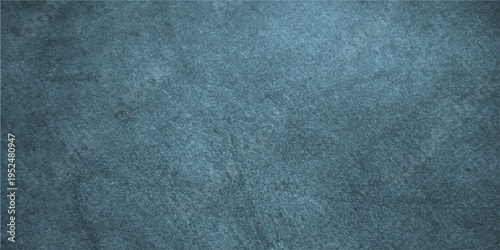 A textured, monochrome, gray-blue backdrop offers a visual experience. The rugged texture of the surface and its subtle shades provide depth and interest for various uses.