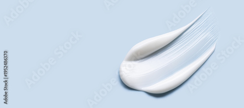 Foto cosmetic cream smear, smooth and shiny texture, blue background