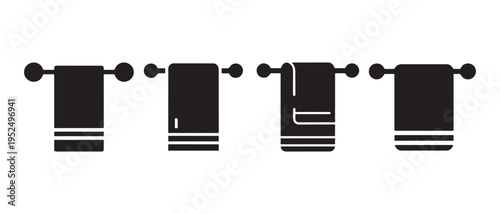 Four black towels hanging on a decorative towel rack.