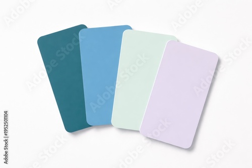 Four pastel colored paper swatches arranged on a white background